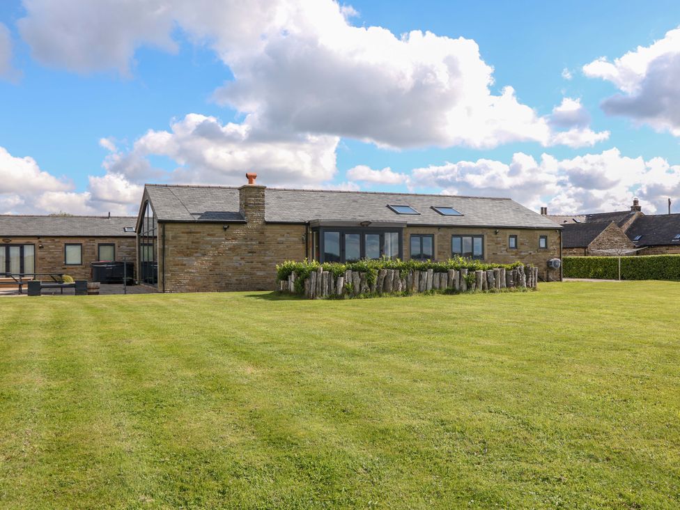A house with a garden and grass at Highgate house in Holmesfield near Dronfield