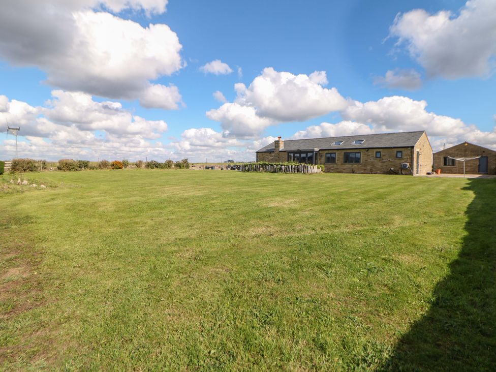 A house with a garden and sky at Highgate house in Holmesfield near Dronfield