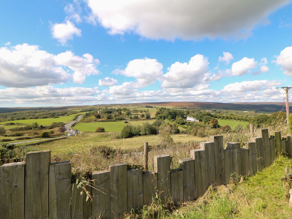 A scenic view of a landscape with a fence and trees at Highgate house in Holmesfield near Dronfield