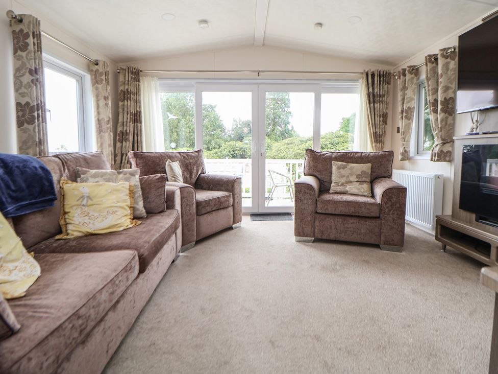 A living room with sofas and a television at 96 Ruthin
