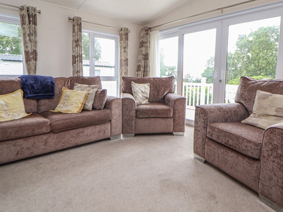 A living room with sofas and windows at 96 Ruthin