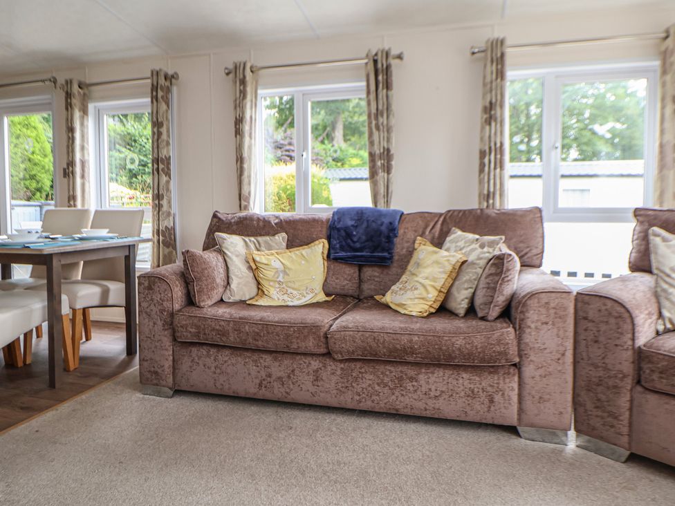 A living room with a sofa and dining table at 96 Ruthin