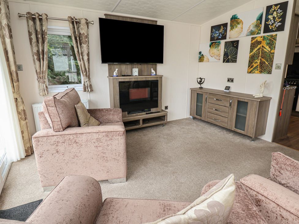A living room with a television and sofa at 96 Ruthin