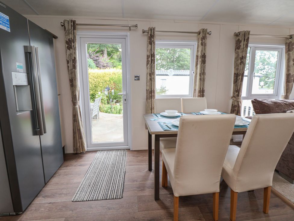 A dining room with a table and chairs at 96 Ruthin