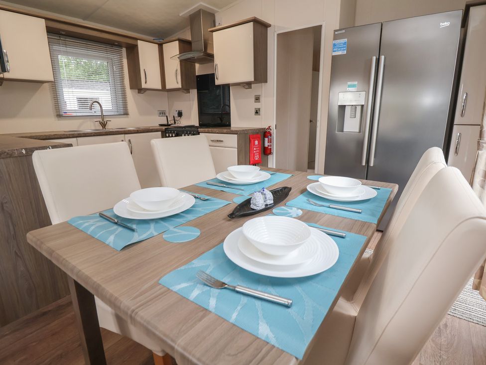 A kitchen with dining table and refrigerator at 96 Ruthin
