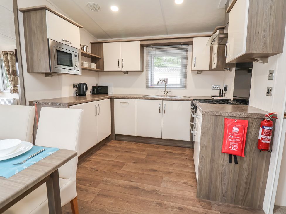 A kitchen with appliances and cabinets at 96 Ruthin