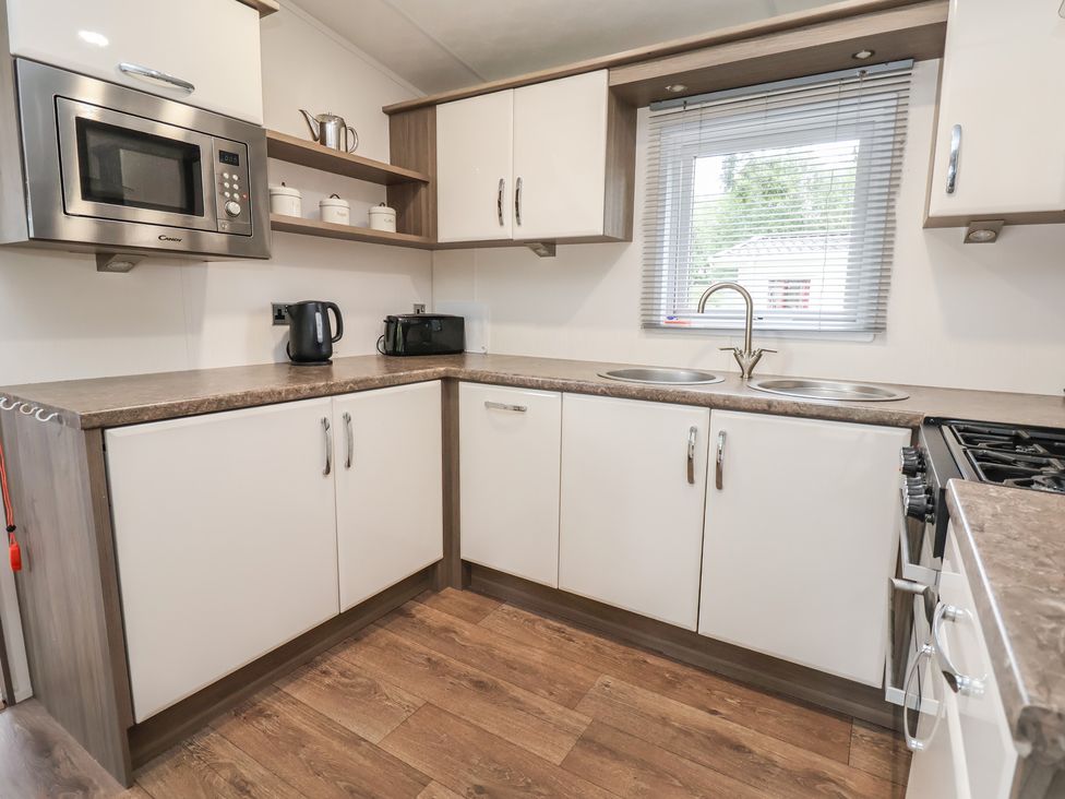 A kitchen with appliances and cabinets at 96 Ruthin