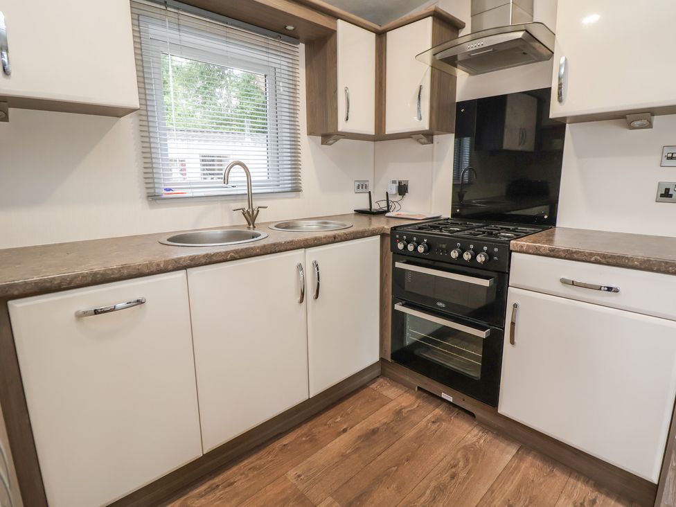 A kitchen with a sink and oven at 96 Ruthin