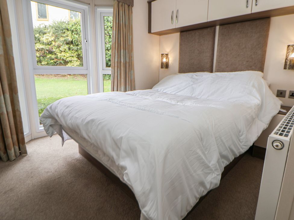 A bedroom with a bed and windows at 96 Ruthin