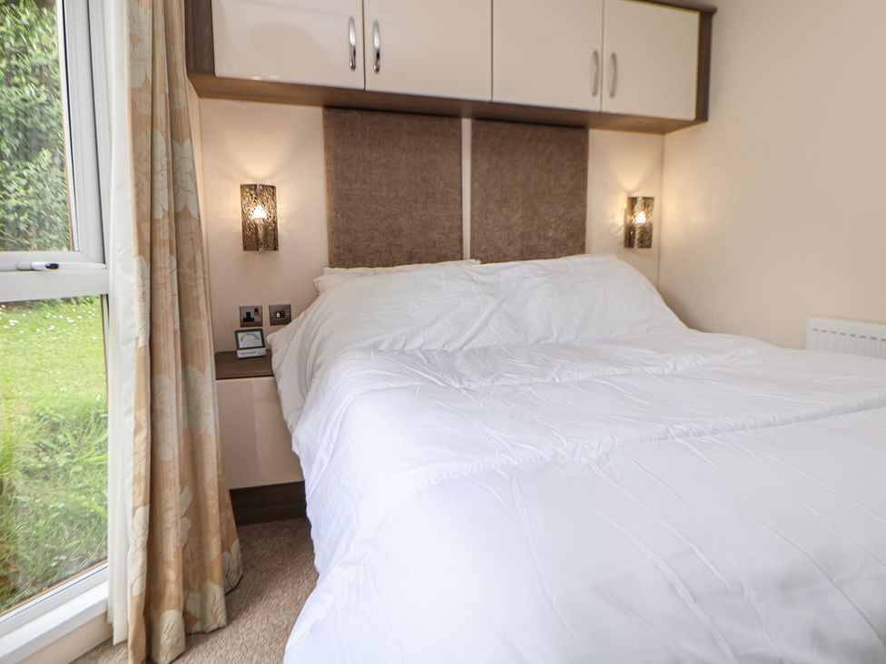 A bedroom with a bed and curtains at 96 in Ruthin
