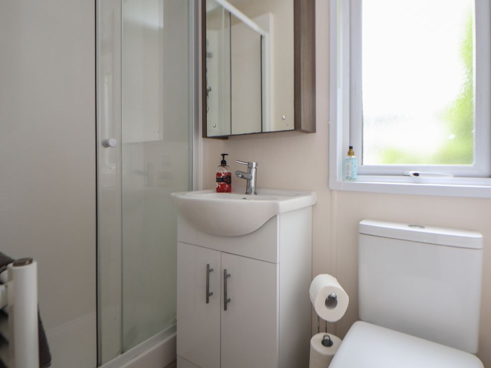 A bathroom with a sink, shower and toilet at 96, Ruthin