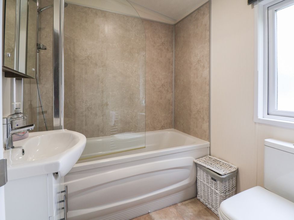A bathroom with a bathtub a sink and a toilet at 96 Ruthin