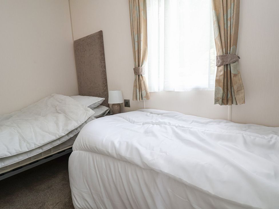A bedroom with beds and window at 96 Ruthin