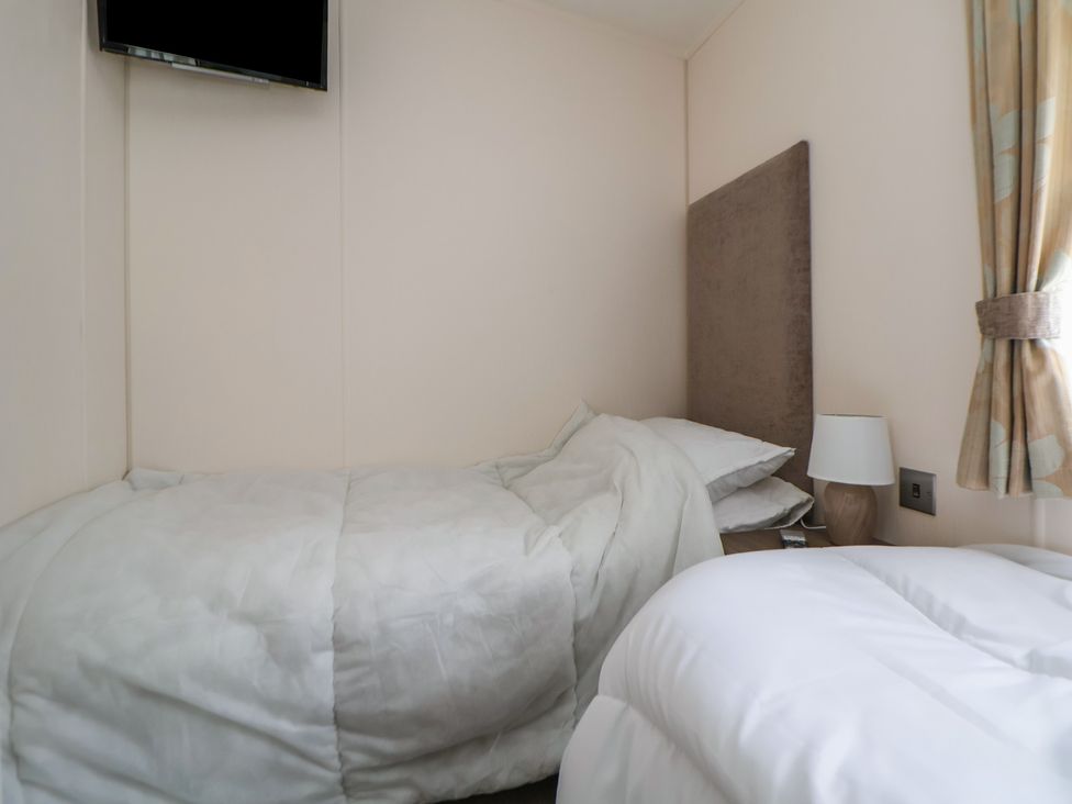 A bedroom with a bed and a lamp at 96 Ruthin
