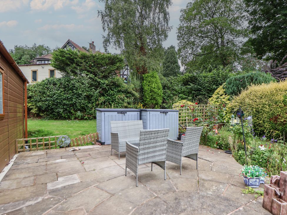 A garden with a patio area and furniture at 96 Ruthin