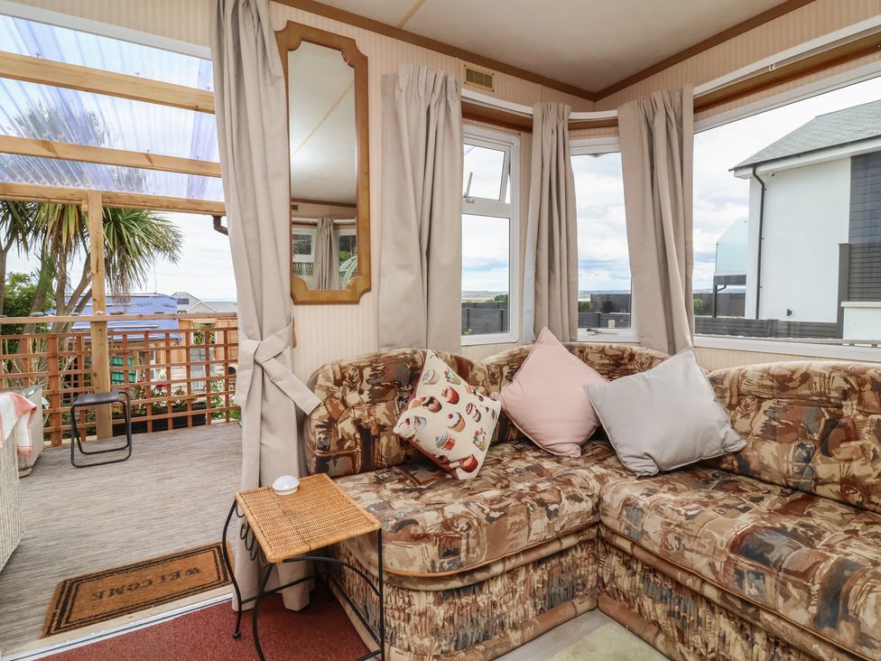 A snug area with a couch and pillows at Big Bertha by the Sea in Northam