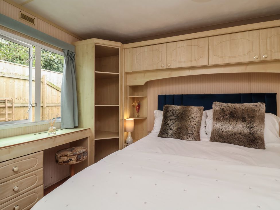 A bedroom with a bed and a desk at Big Bertha by the Sea in Northam