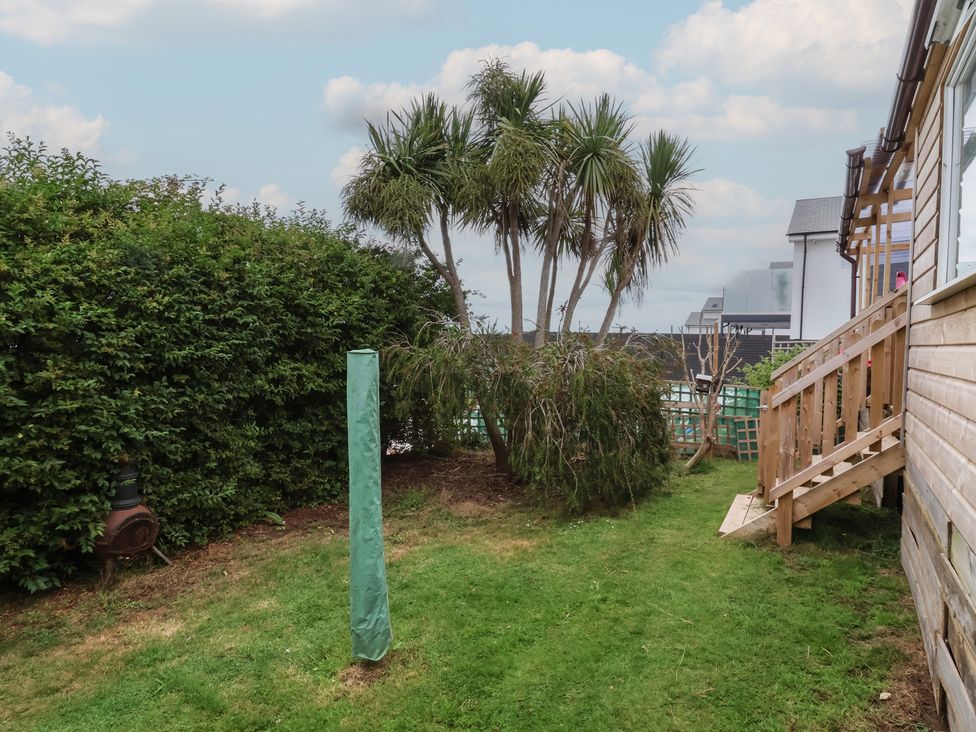 A garden with palm trees and a staircase at Big Bertha by the Sea, Northam