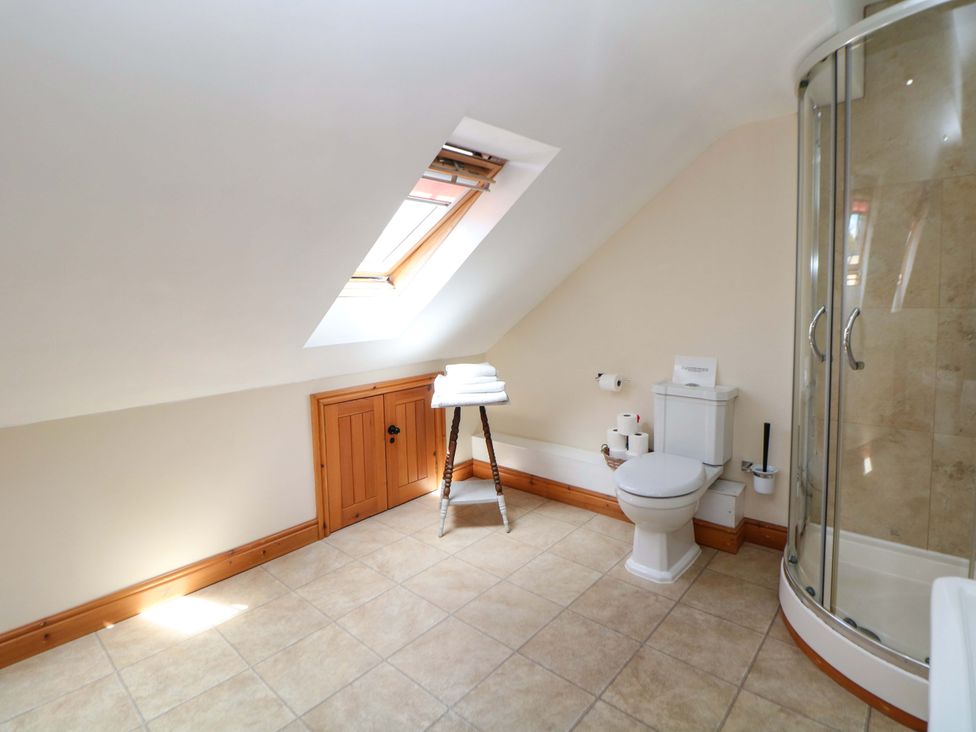 A bathroom with a shower and toilet at Hollow Brook Cottage in Hope Valley