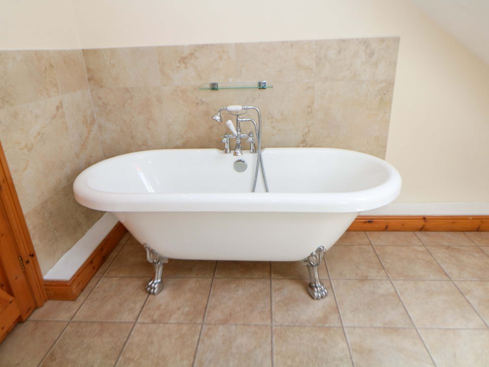 A bathtub with faucet in a bathroom at Hollow Brook Cottage Hope Valley