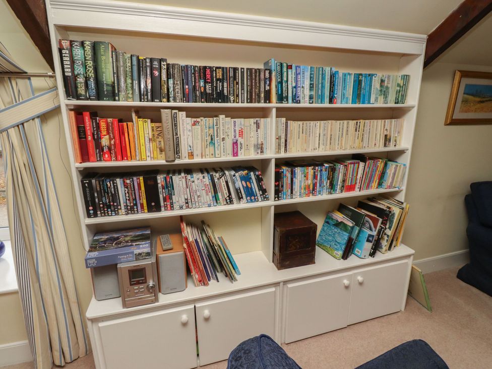 A bookshelf with books and DVDs at Honeymug in Branton near Powburn
