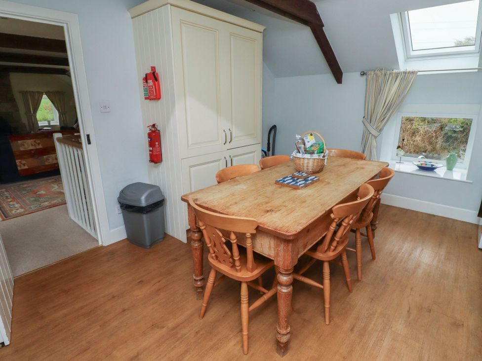 A kitchen with a dining table and chairs at Honeymug Branton near Powburn