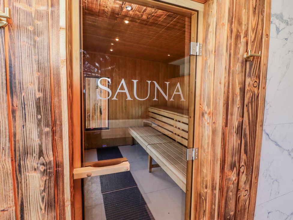 A sauna entrance with wooden benches and mats at Honeymug Branton near Powburn