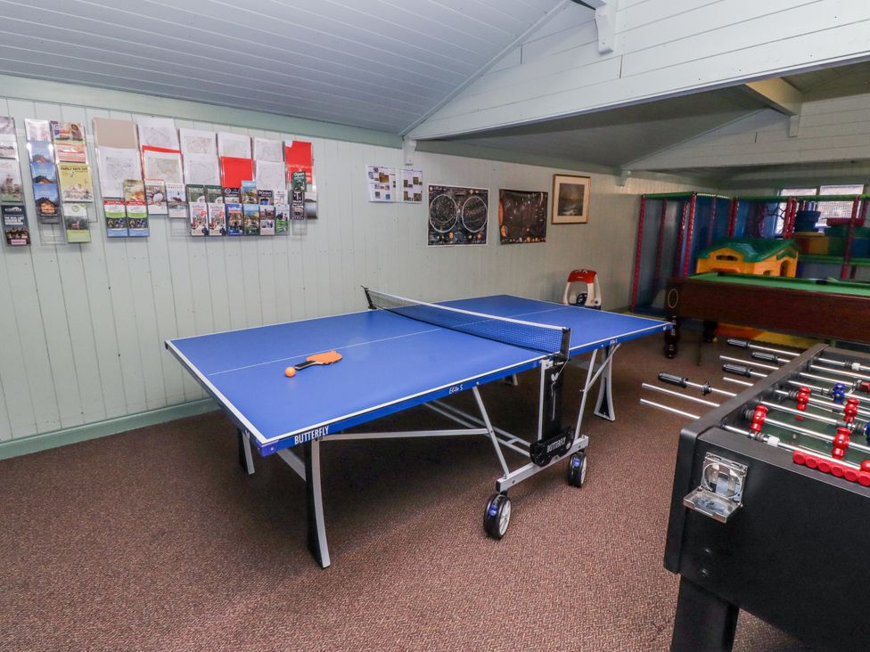A game room with a ping pong table and foosball table at Honeymug near Branton Powburn