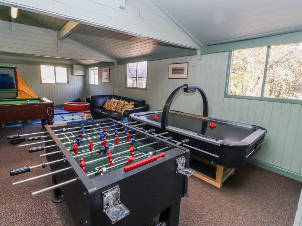 A game room with a foosball table and air hockey table at Honeymug in Branton near Powburn