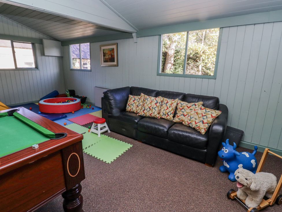 A snug with a pool table and a sofa at Honeymug in Branton near Powburn