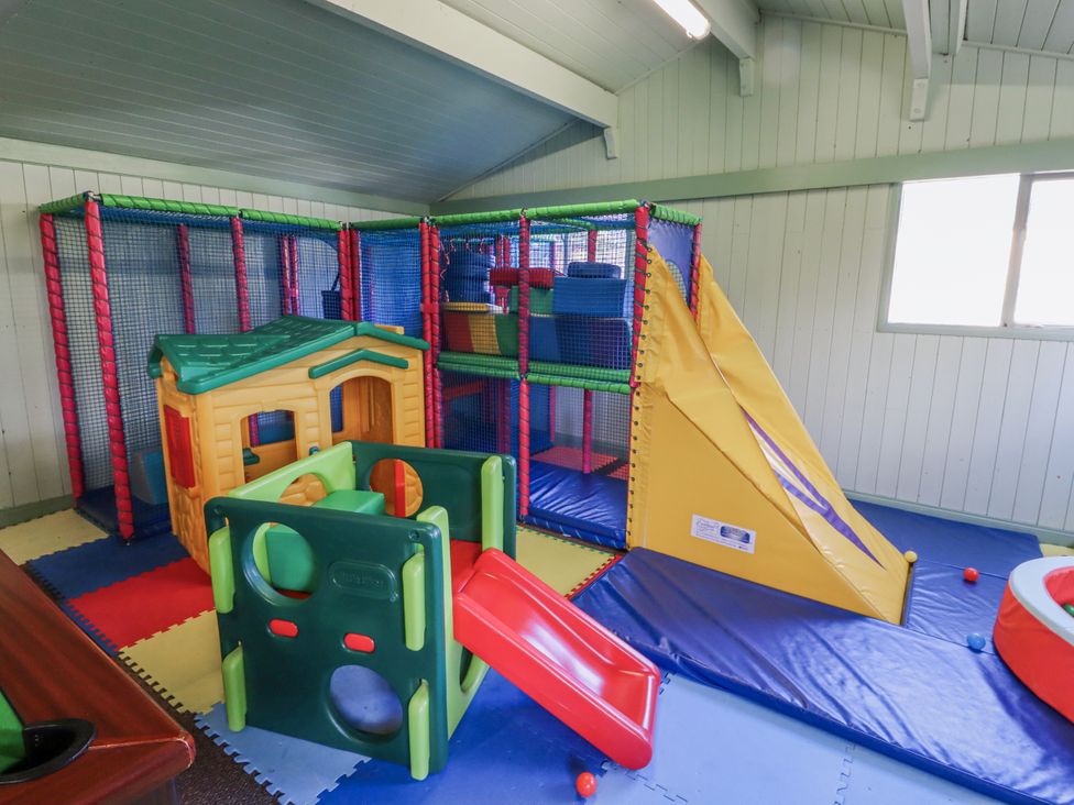A playroom with a play structure and slide at Honeymug in Branton near Powburn