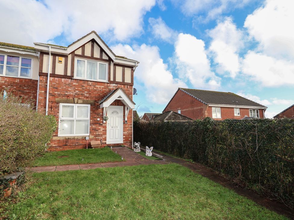 A house with a lawn and pathway at The Cosy View in Paignton