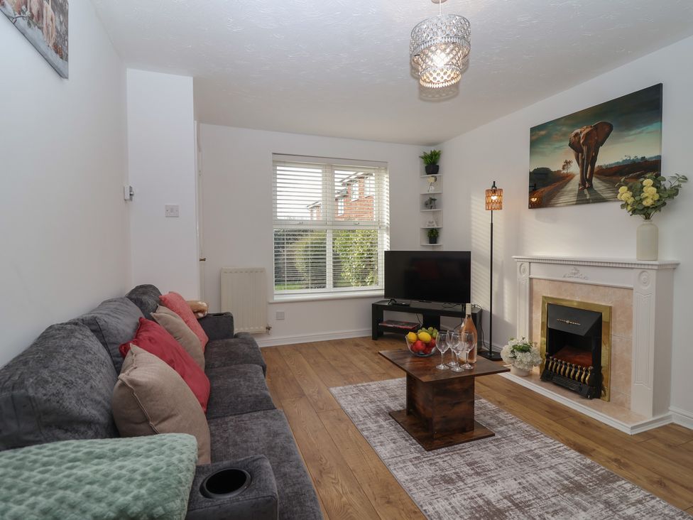 A living room with a television and a coffee table at The Cosy View in Paignton