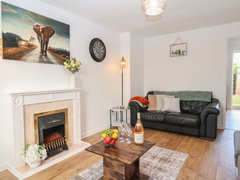 A living room with a sofa and fireplace at The Cosy View in Paignton