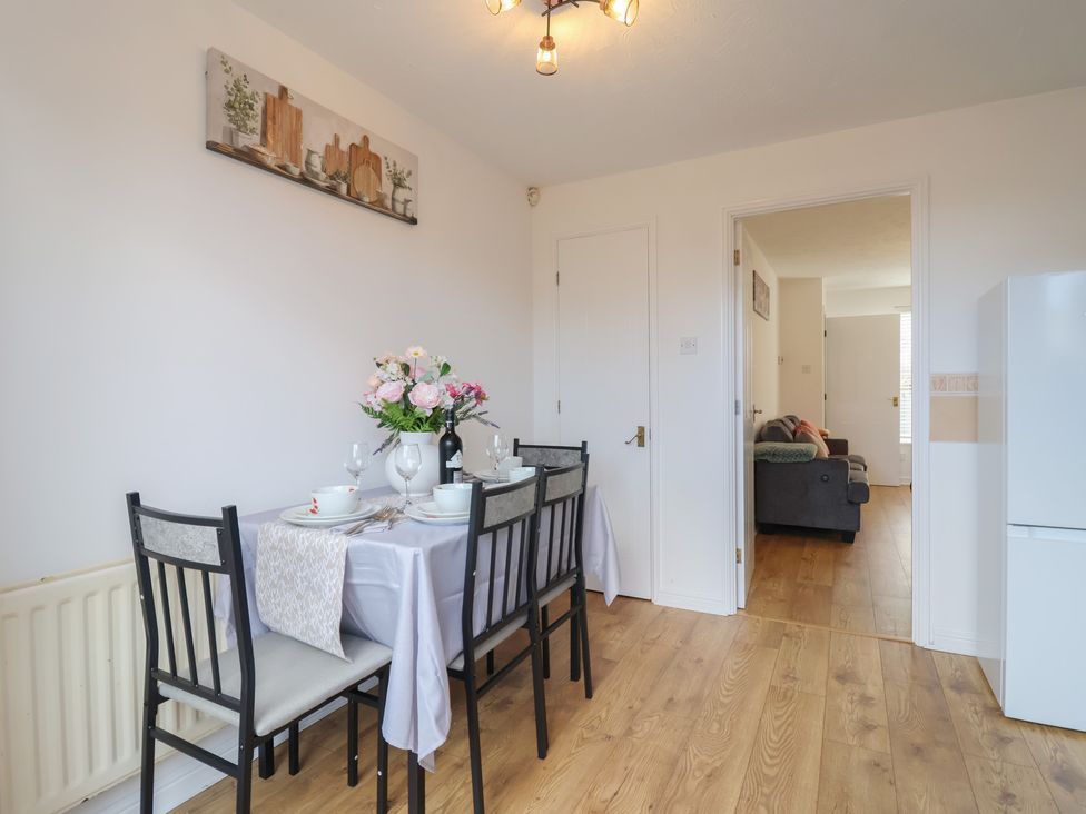A dining room with a table set for a meal at The Cosy View in Paignton