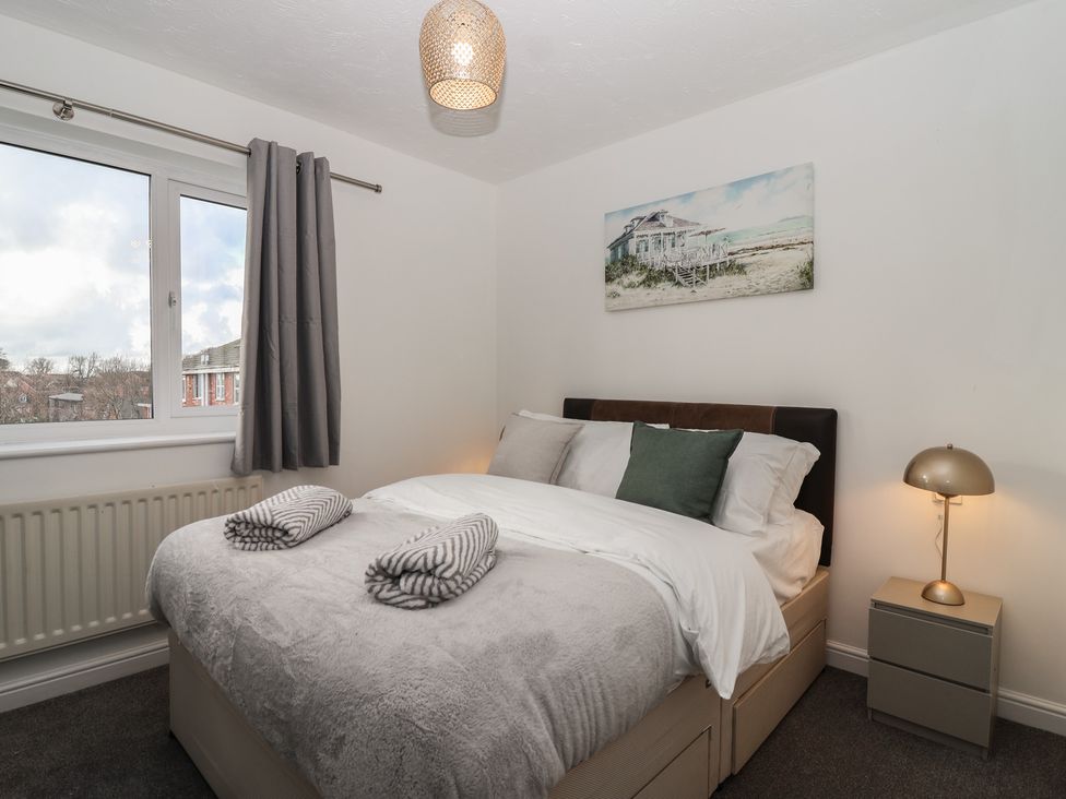A bedroom with a bed and window at The Cosy View in Paignton