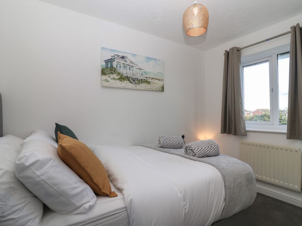 A bedroom with a bed and a window at The Cosy View in Paignton