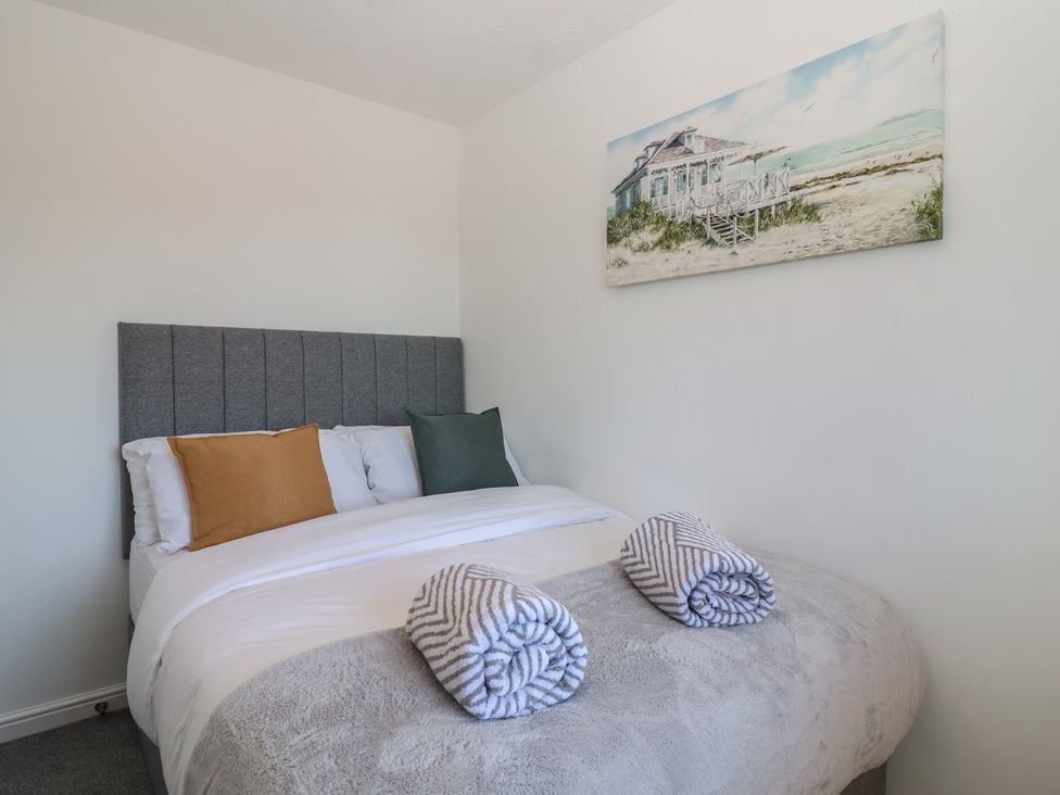 A bedroom with a bed and pillows at The Cosy View in Paignton