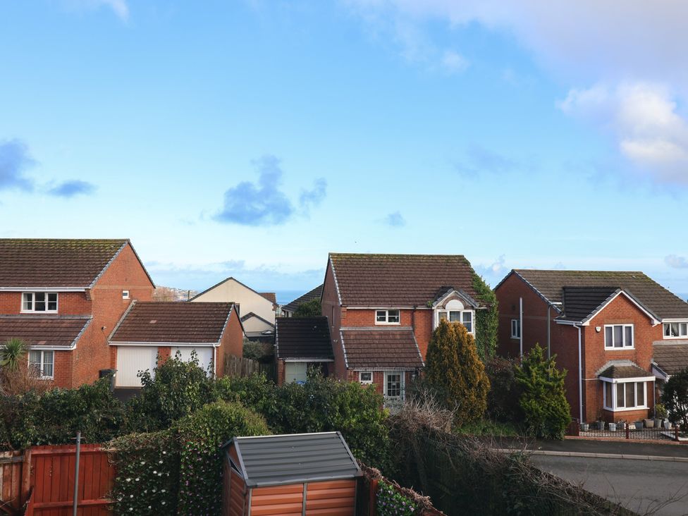 A view of houses with rooftops and trees at The Cosy View in Paignton