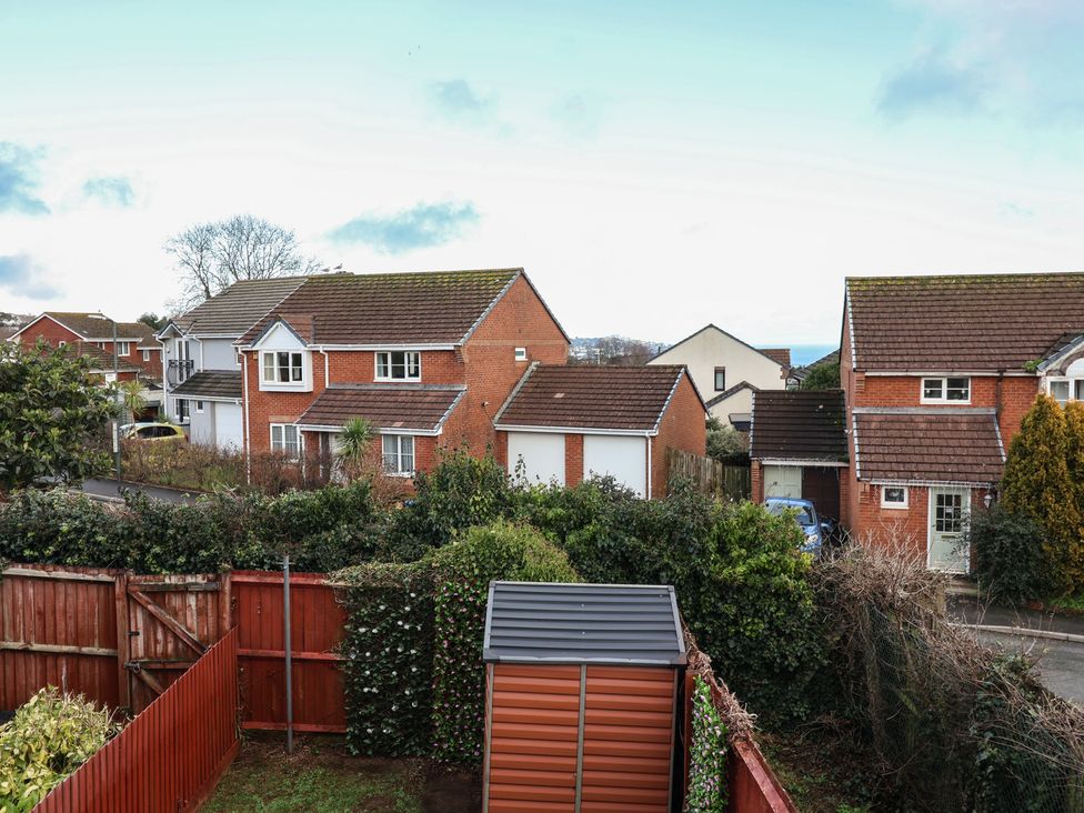 A view of houses and a garden at The Cosy View in Paignton