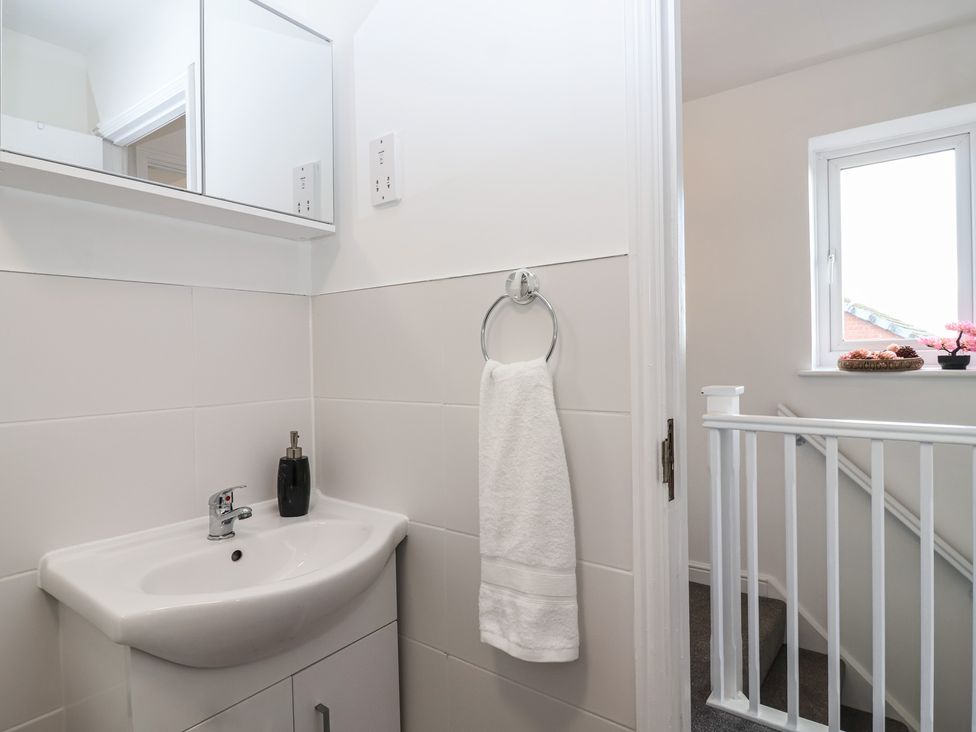 A bathroom with a sink and towel holder at The Cosy View in Paignton