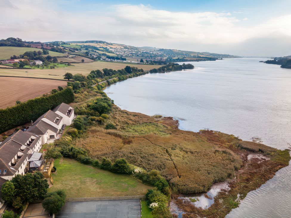 A landscape with a river and houses at Goldfinch in Kingsteignton