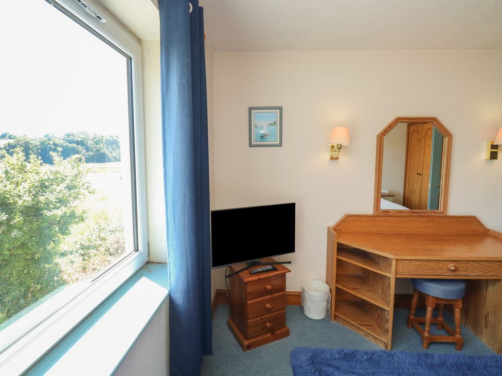 A bedroom with a desk and tv at Teal in Newton Abbot