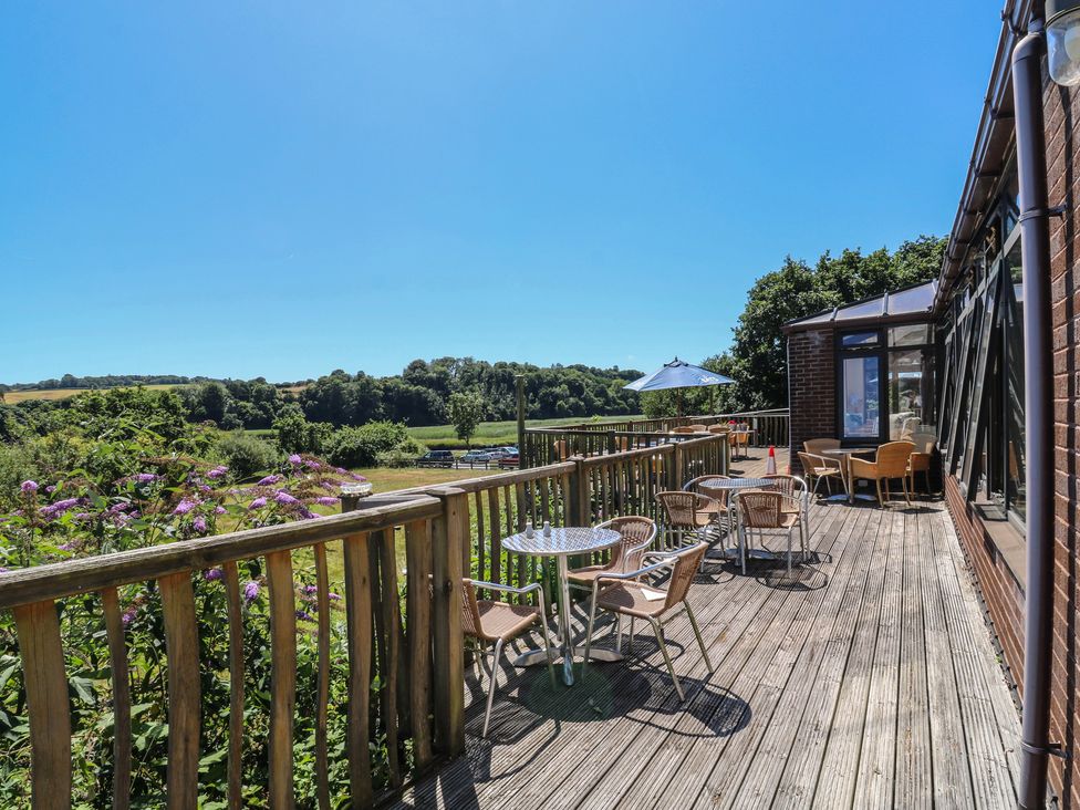 An outdoor area with wooden decking and seating at Teal in Newton Abbot