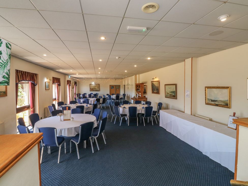 A dining room with round tables and chairs at Swift in Newton Abbot