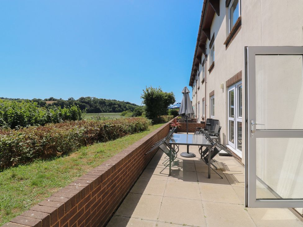 An outdoor patio with a table and chairs at Avocet in Newton Abbot