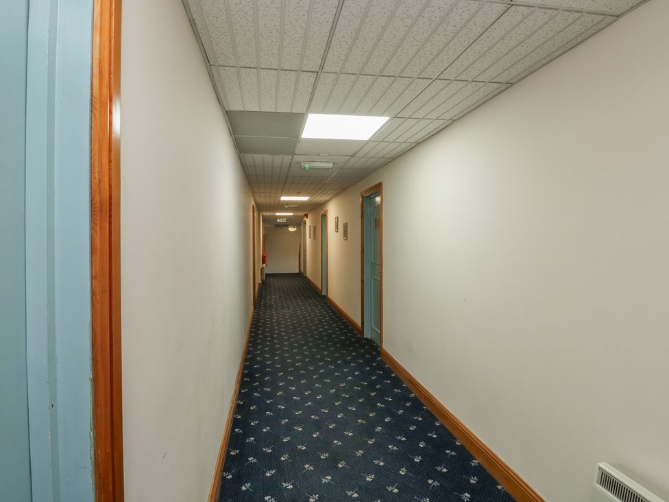 A hallway with doors on both sides at Sycamore in Newton Abbot