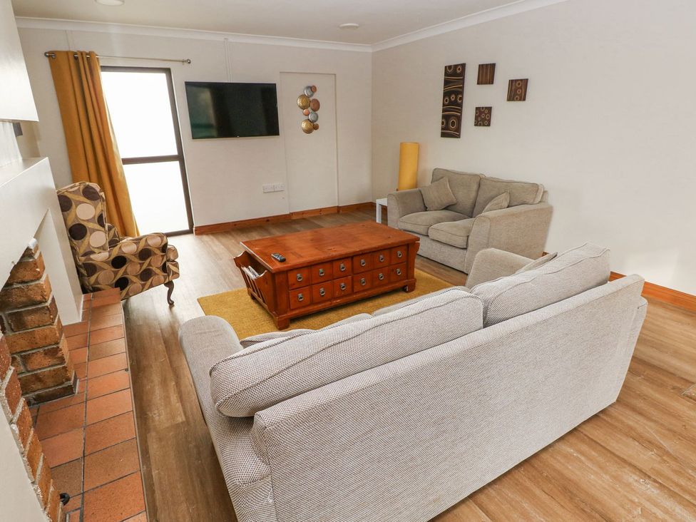 A living room with a sofa and coffee table at Tig Bhan in Narberth
