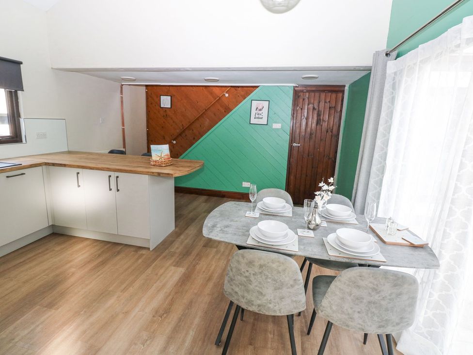 A dining area with a table and chairs at Cuddfan in Narberth