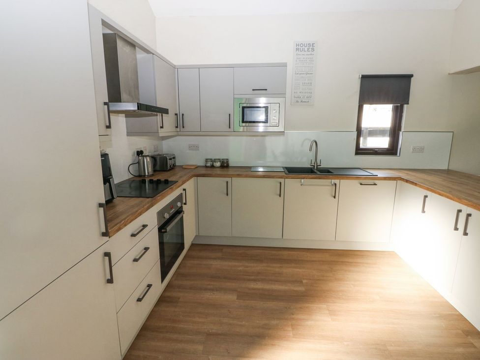 A kitchen with cabinets and appliances at Cuddfan in Narberth